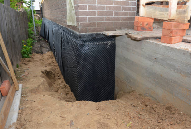 Happy homeowners after waterproofing job in Mingo